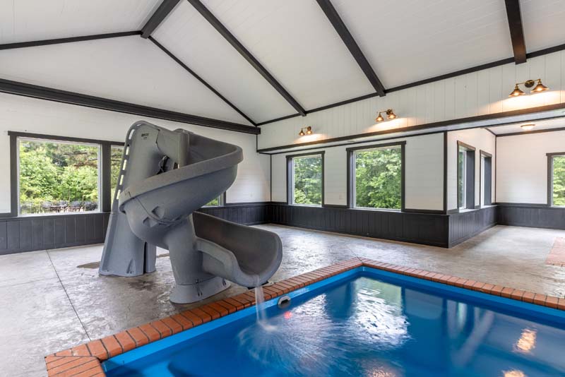 Indoor pool spiral water slide — Black Eagle Lodge
