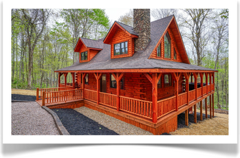 side of wrap around deck with jacuzzi in back next to woods