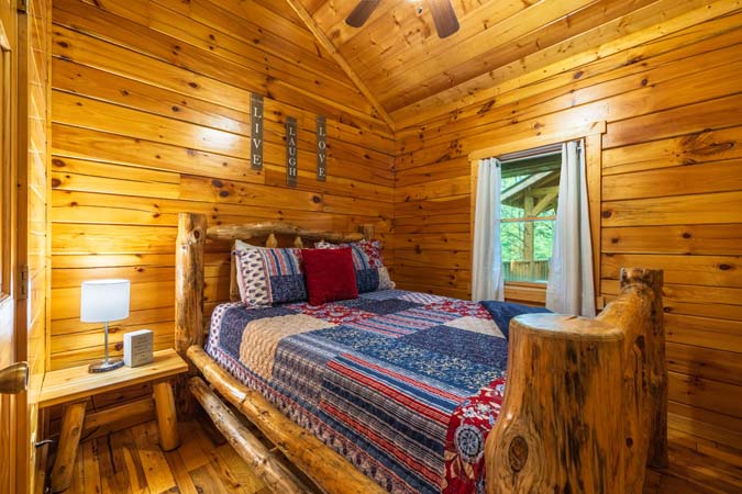Bedroom with a queen log bed — Leaning Tree Cabin