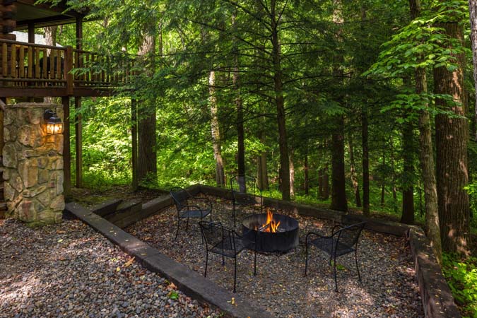 Outdoor firepit ringed with chairs — Leaning Tree Cabin