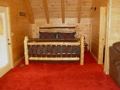 bedroom with log bed and red carpet