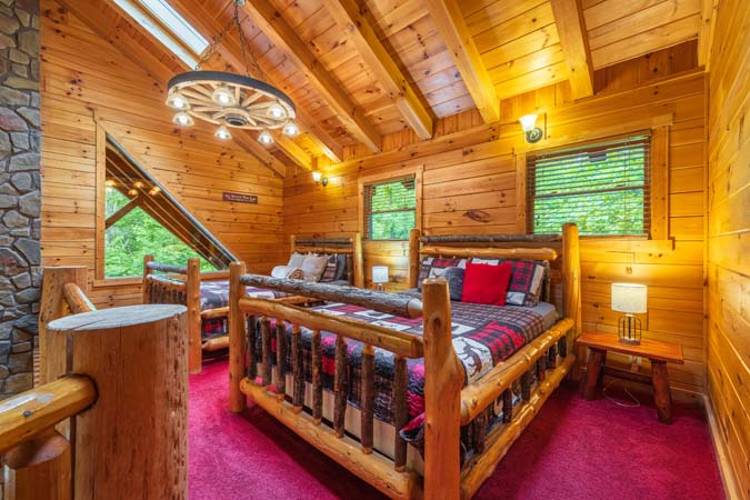 Honeymoon suite living area with a stone fireplace — Timber Ridge Lodge