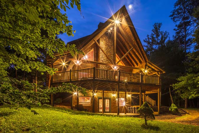 Covered deck dining beside the outdoor fireplace — Timber Ridge Lodge