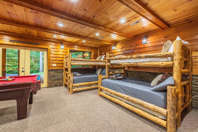 Lower-level bunk room with log bunks — Timber Ridge Lodge