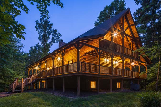 Rear of the lodge lit up at dusk — Timber Ridge Lodge