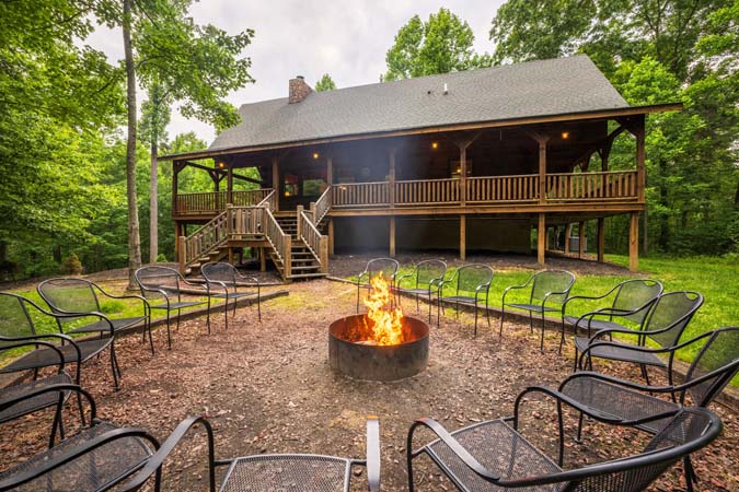 Outdoor firepit ringed with chairs — Timber Ridge Lodge