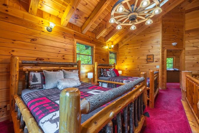 Loft bedroom with two queen log beds — Timber Ridge Lodge