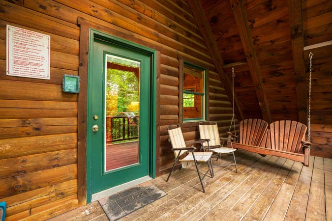 Covered porch with a swing — Timber Ridge Lodge