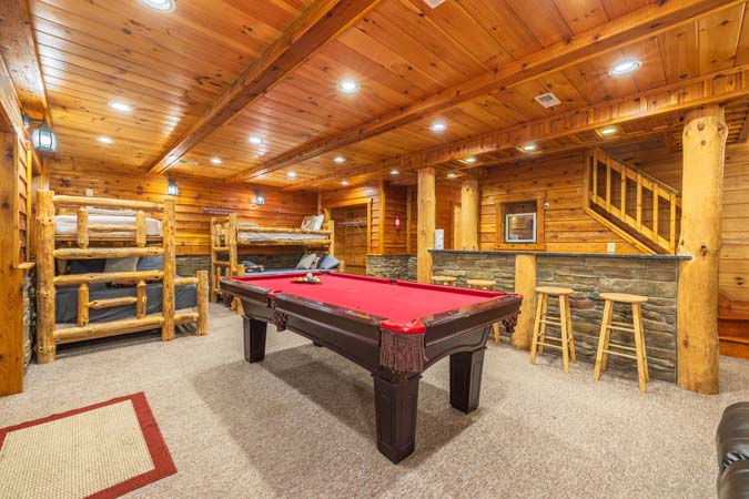 Great room with a stone wood-burning fireplace — Timber Ridge Lodge