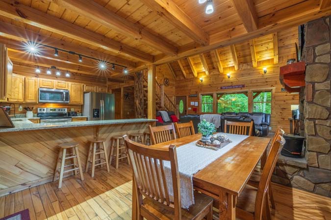 Lower-level game room with a pool table and log bunks — Timber Ridge Lodge
